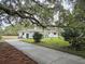 Charming single-story white brick home with a long driveway and mature trees with Spanish moss at 488 Society Rd # A&B, McClellanville, SC 29458