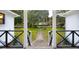 Inviting view of a manicured front lawn and sidewalk, as seen from the charming front porch at 488 Society Rd # A&B, McClellanville, SC 29458