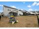 Large backyard featuring a trampoline, swing set, and space for entertaining at 491 Richfield Way, Summerville, SC 29486
