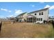 Spacious fenced backyard featuring a screened porch, outdoor seating, and a playset at 491 Richfield Way, Summerville, SC 29486