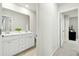 Bright bathroom featuring double vanity sinks, white cabinetry, and a large mirror at 491 Richfield Way, Summerville, SC 29486