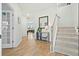 Inviting home foyer featuring hardwood floors, staircase, and stylish accents at 491 Richfield Way, Summerville, SC 29486