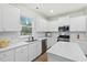Bright kitchen with granite countertops, white cabinets, and stainless steel appliances at 491 Richfield Way, Summerville, SC 29486
