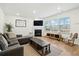 Inviting living room features a cozy fireplace, hardwood floors, and lots of natural light from large windows at 491 Richfield Way, Summerville, SC 29486