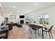 Open-concept living room boasts hardwood floors, fireplace, and ample natural light at 491 Richfield Way, Summerville, SC 29486