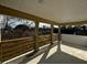Covered outdoor balcony space with wooden railings offering a serene view of the neighborhood at 515 Joseph St, Charleston, SC 29412