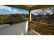 View from balcony of home with wooden railing overlooking street and trees on a partly cloudy day at 515 Joseph St, Charleston, SC 29412