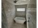 Modern bathroom featuring a soaking tub, tiled walls, a shower with glass door and sleek fixtures at 515 Joseph St, Charleston, SC 29412