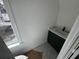 Cozy bathroom nook with a dark green vanity and a window providing natural light at 515 Joseph St, Charleston, SC 29412