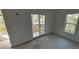Clean bedroom with white walls, sliding door to balcony, and natural light from two windows at 515 Joseph St, Charleston, SC 29412