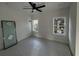 Bedroom featuring a ceiling fan, two windows offering natural light, and a glass panel on the side at 515 Joseph St, Charleston, SC 29412