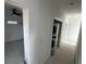 View of hallway featuring laundry closet and view into a bright room with ceiling fan at 515 Joseph St, Charleston, SC 29412