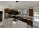 Modern kitchen with dark cabinetry, stainless steel appliances, and a large marble island at 515 Joseph St, Charleston, SC 29412