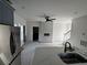Open-concept kitchen with an island, a sink and modern appliances, with a view to a staircase at 515 Joseph St, Charleston, SC 29412