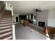 Unfinished open-concept living space with a fireplace, stairs, and kitchen area at 515 Joseph St, Charleston, SC 29412