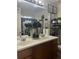 Bathroom vanity with double sinks, black hardware, decorative plants and a large framed mirror at 527 Travelers Blvd, Summerville, SC 29485