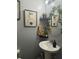 Charming bathroom with modern art, floating shelves, and a sleek pedestal sink at 527 Travelers Blvd, Summerville, SC 29485