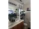 Bathroom vanity with double sinks, black hardware, decorative plants and a large framed mirror at 527 Travelers Blvd, Summerville, SC 29485