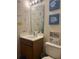 Bright bathroom featuring a white vanity, framed mirror, and colorful fish decorations on the wall at 527 Travelers Blvd, Summerville, SC 29485