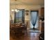 Warm dining space with a round wood table and elegant chandelier, adjacent to a light-filled doorway at 527 Travelers Blvd, Summerville, SC 29485