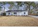 Charming renovated one-story home featuring a new roof, white siding, and mature trees in front at 5816 Sedgefield Dr, Hanahan, SC 29410