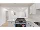 Modern kitchen with white cabinets, quartz countertop, and stainless steel appliances at 5816 Sedgefield Dr, Hanahan, SC 29410