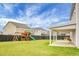 Backyard featuring large, fenced yard, covered patio, and play set at 619 Ravens Wood Rd, Summerville, SC 29486