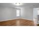 Spacious bedroom with modern light fixture, window, and hardwood flooring at 619 Ravens Wood Rd, Summerville, SC 29486