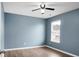 Stylish blue bedroom features a ceiling fan and large bright window at 619 Ravens Wood Rd, Summerville, SC 29486