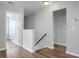 Bright hallway features hardwood floors and neutral paint, leading to other rooms at 619 Ravens Wood Rd, Summerville, SC 29486