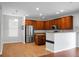 Modern kitchen boasts stainless steel appliances, granite countertops, and wood cabinets for culinary delights at 619 Ravens Wood Rd, Summerville, SC 29486
