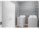 Laundry room includes a washer, dryer, shelving, and cabinets at 619 Ravens Wood Rd, Summerville, SC 29486