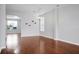 Bright living room boasts hardwood floors, neutral walls, and an elegant chandelier for a welcoming feel at 619 Ravens Wood Rd, Summerville, SC 29486
