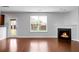 Spacious living room with a fireplace, a large window, and a door for outdoor access at 619 Ravens Wood Rd, Summerville, SC 29486