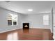 Living room with fireplace, large windows, and recessed lights for natural light and cozy ambiance at 619 Ravens Wood Rd, Summerville, SC 29486