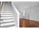 Bright living room boasts hardwood floors, neutral walls, staircase, and an elegant chandelier for a welcoming feel at 619 Ravens Wood Rd, Summerville, SC 29486