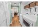 Convenient laundry room with modern appliances, storage and an attached kitchen at 620 Baytree Ct, Mount Pleasant, SC 29464