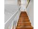 Wooden staircase with white railings, showing a carpeted runner and natural light at 620 Baytree Ct, Mount Pleasant, SC 29464