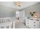 Stylish Bedroom with white furniture, unique wallpaper, and a modern light fixture at 621 Red Monarch Way, Moncks Corner, SC 29461