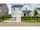 Charming two-story home with a white garage door, complemented by a dark wooden fence at 621 Red Monarch Way, Moncks Corner, SC 29461