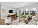 Bright living room with hardwood floors, ample seating, large windows, and stylish decor at 629 Red Monarch Way, Moncks Corner, SC 29461