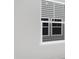 Modern white window with view of the exterior gray siding of a home at 629 Red Monarch Way, Moncks Corner, SC 29461