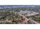 Scenic aerial view of a home nestled among trees near roadways, showcasing neighborhood charm at 69 Folly Road Blvd, Charleston, SC 29407