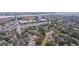 Expansive aerial view of a neighborhood with mature trees, commercial spaces, and water views in the background at 69 Folly Road Blvd, Charleston, SC 29407