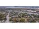 High-angle view showcasing a neighborhood with a mix of mature trees, houses, and nearby waterway at 69 Folly Road Blvd, Charleston, SC 29407