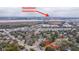 Wide aerial shot overlooking residential homes, roadways, and distant cityscape with waterway and downtown Charleston indicated at 69 Folly Road Blvd, Charleston, SC 29407