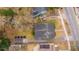 An aerial view of a home with a dark gray roof, a brick walkway, and a gravel drive at 69 Folly Road Blvd, Charleston, SC 29407