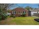 Private backyard with lush green lawn and established trees at 69 Folly Road Blvd, Charleston, SC 29407