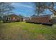 Expansive backyard featuring lush green grass, garden beds, and a brick building at 69 Folly Road Blvd, Charleston, SC 29407