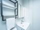 Clean bathroom featuring a modern vanity, a lighted mirror, and wall-mounted shelving unit at 69 Folly Road Blvd, Charleston, SC 29407